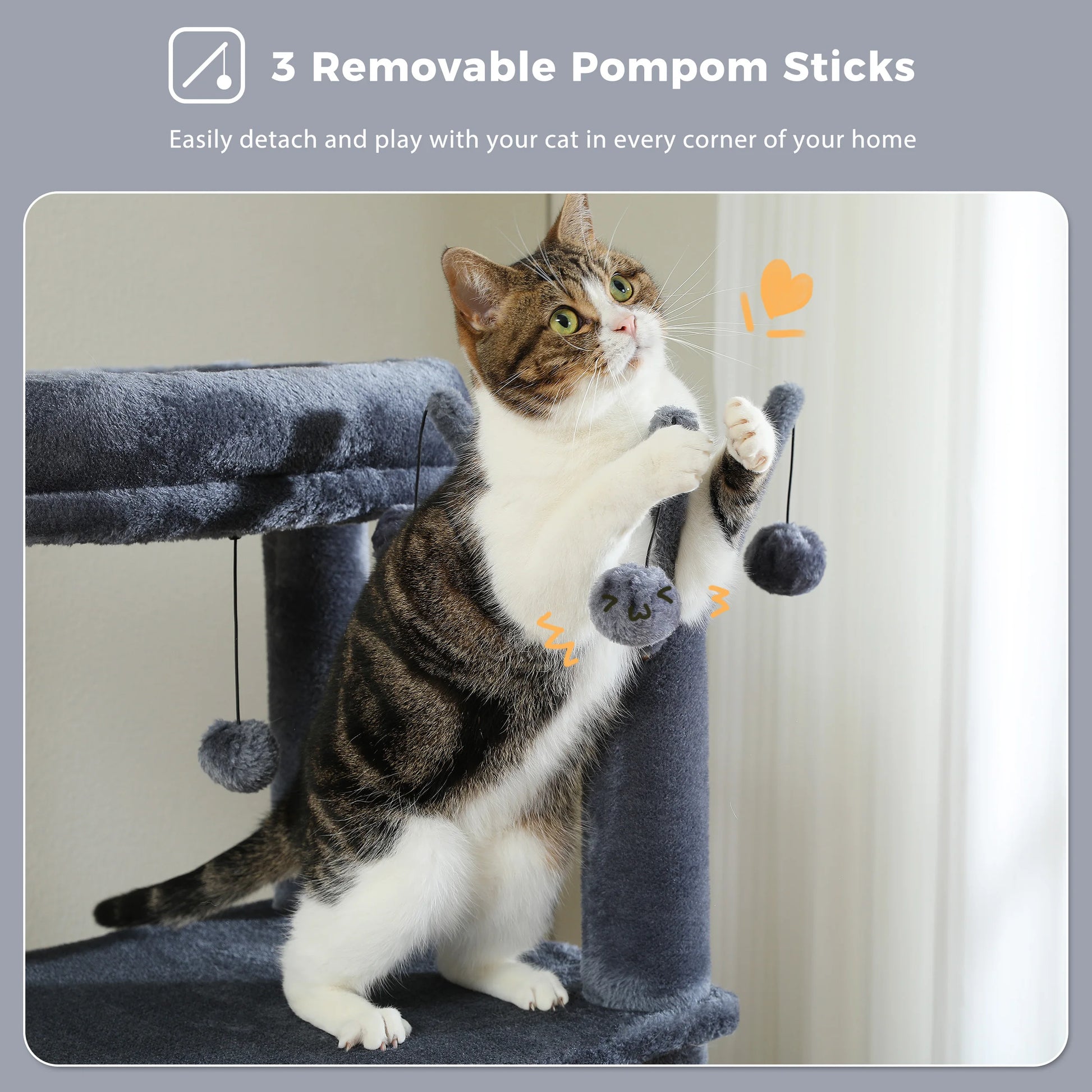 Cat playing with a gray cat tree with removable pom-pom sticks on a light gray background