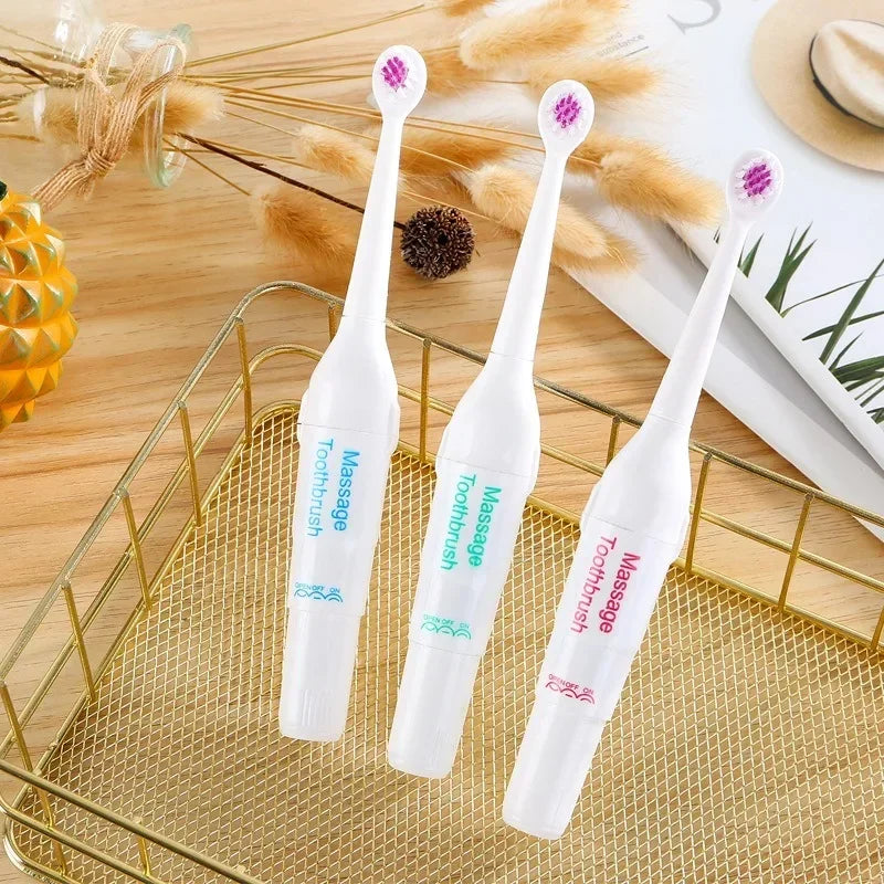 Three white electronic toothbrushes with pink bristle heads on a decorative surface.