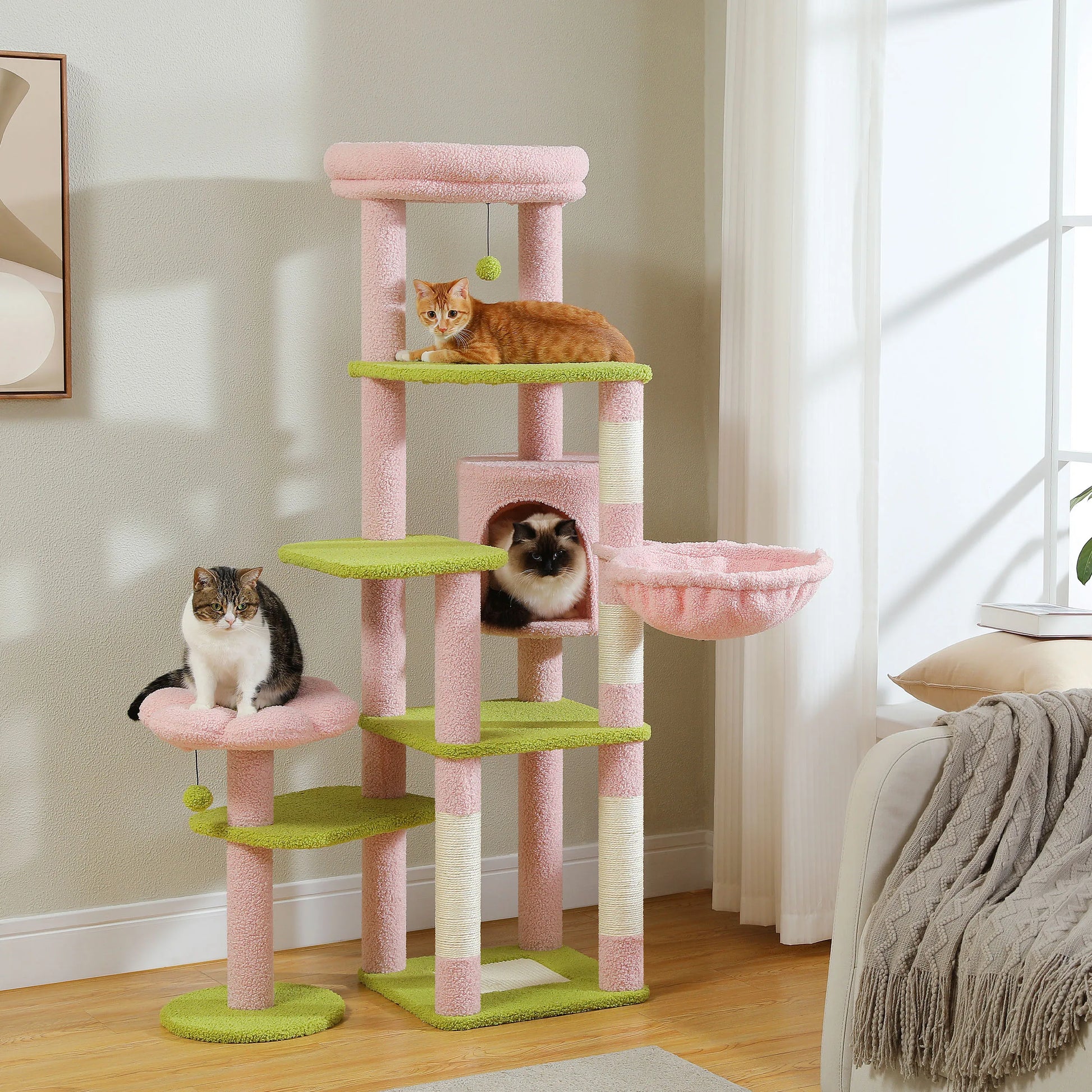 Cat tree with multiple levels and a cat sitting on one of the platforms in a room.
