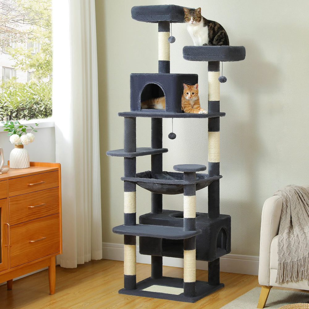 Cat tree with multiple levels and a cat sitting on top in a room with furniture and decor.