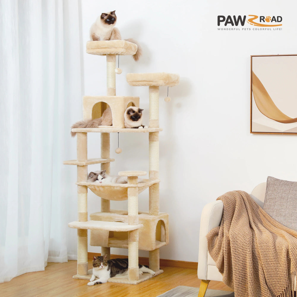 Cat tree with multiple levels and a cat sitting on top in a room with a couch and painting.