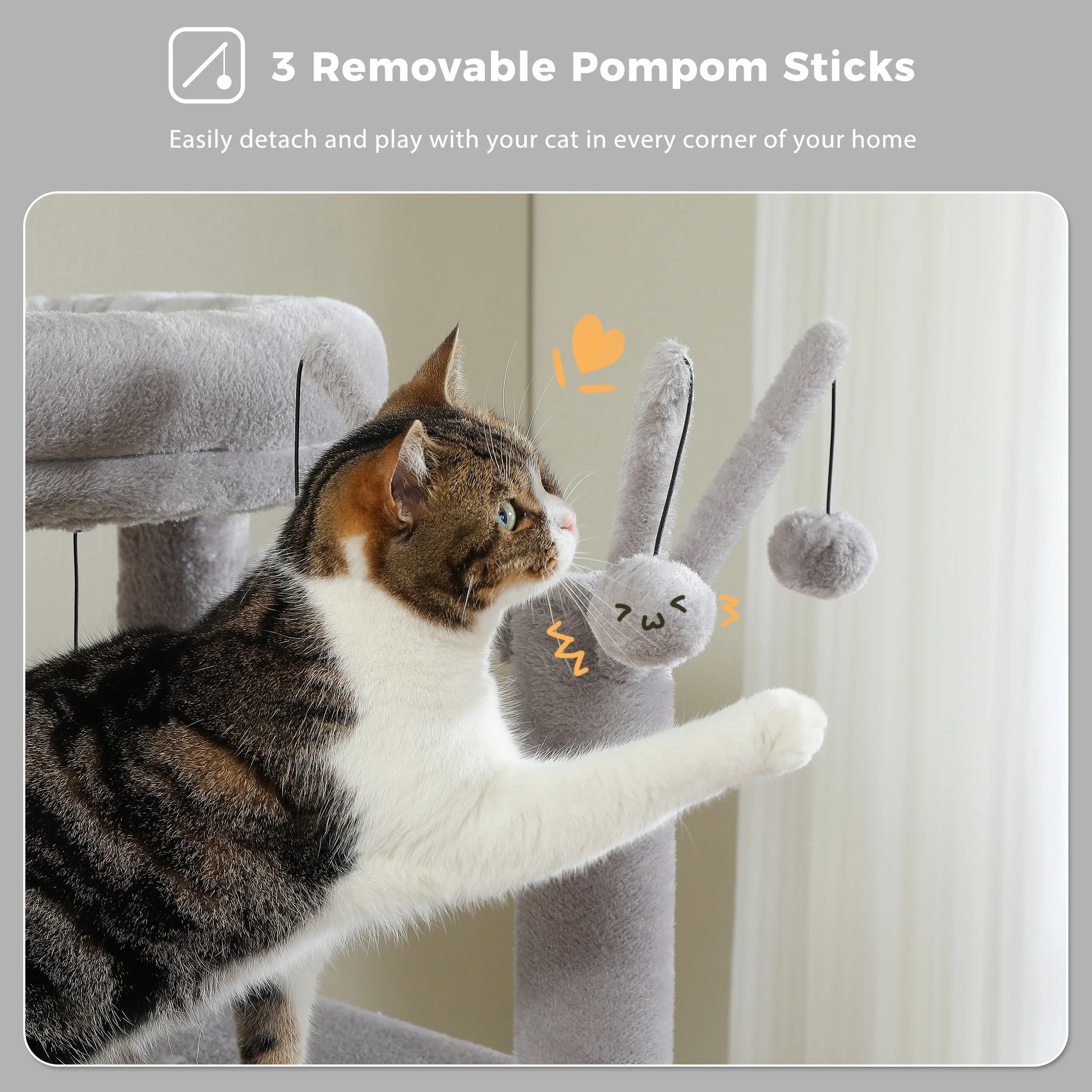 Cat playing with a gray cat toy with removable pom-poms on a light-colored background