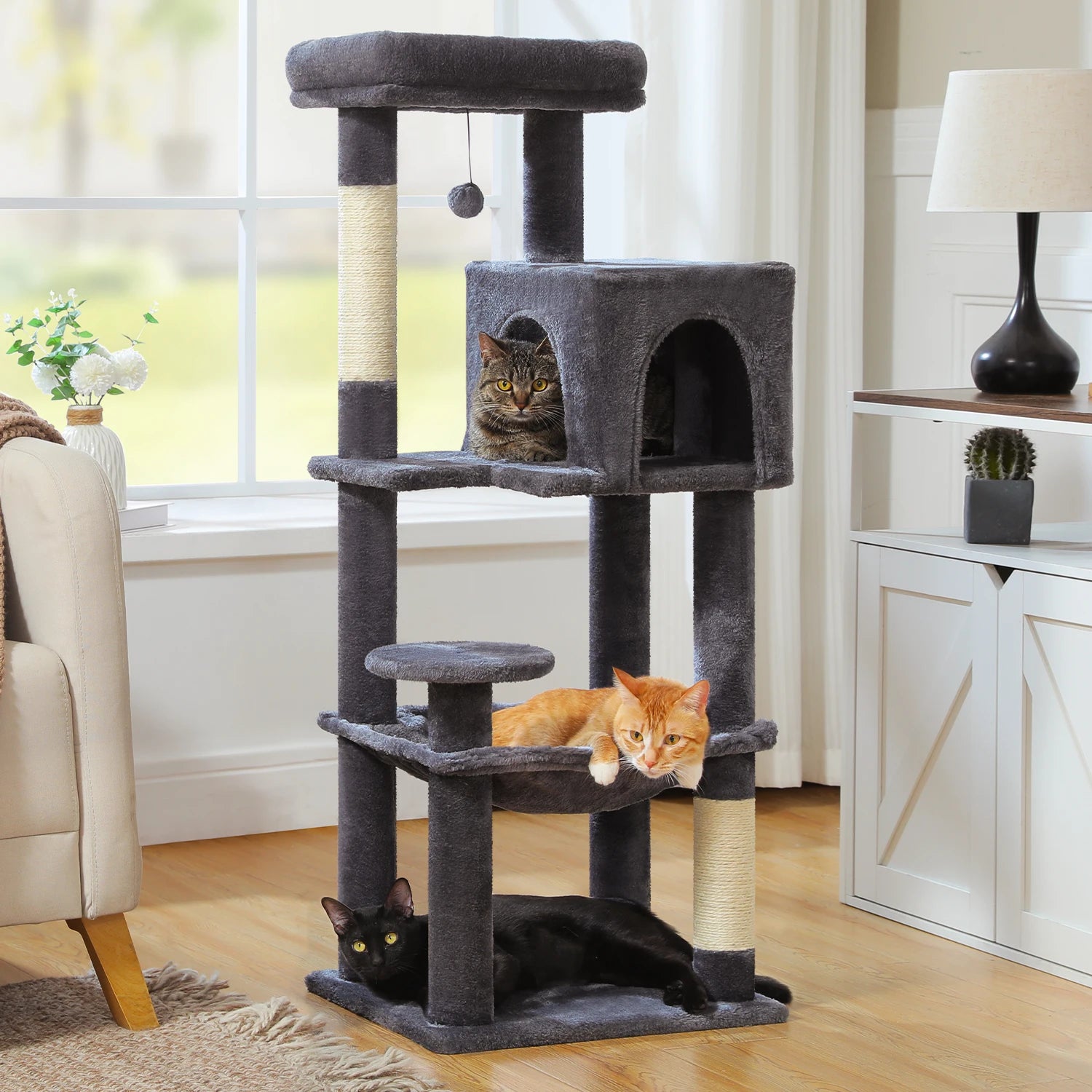 Cat tree with multiple levels and a cat sitting on each level in a living room.