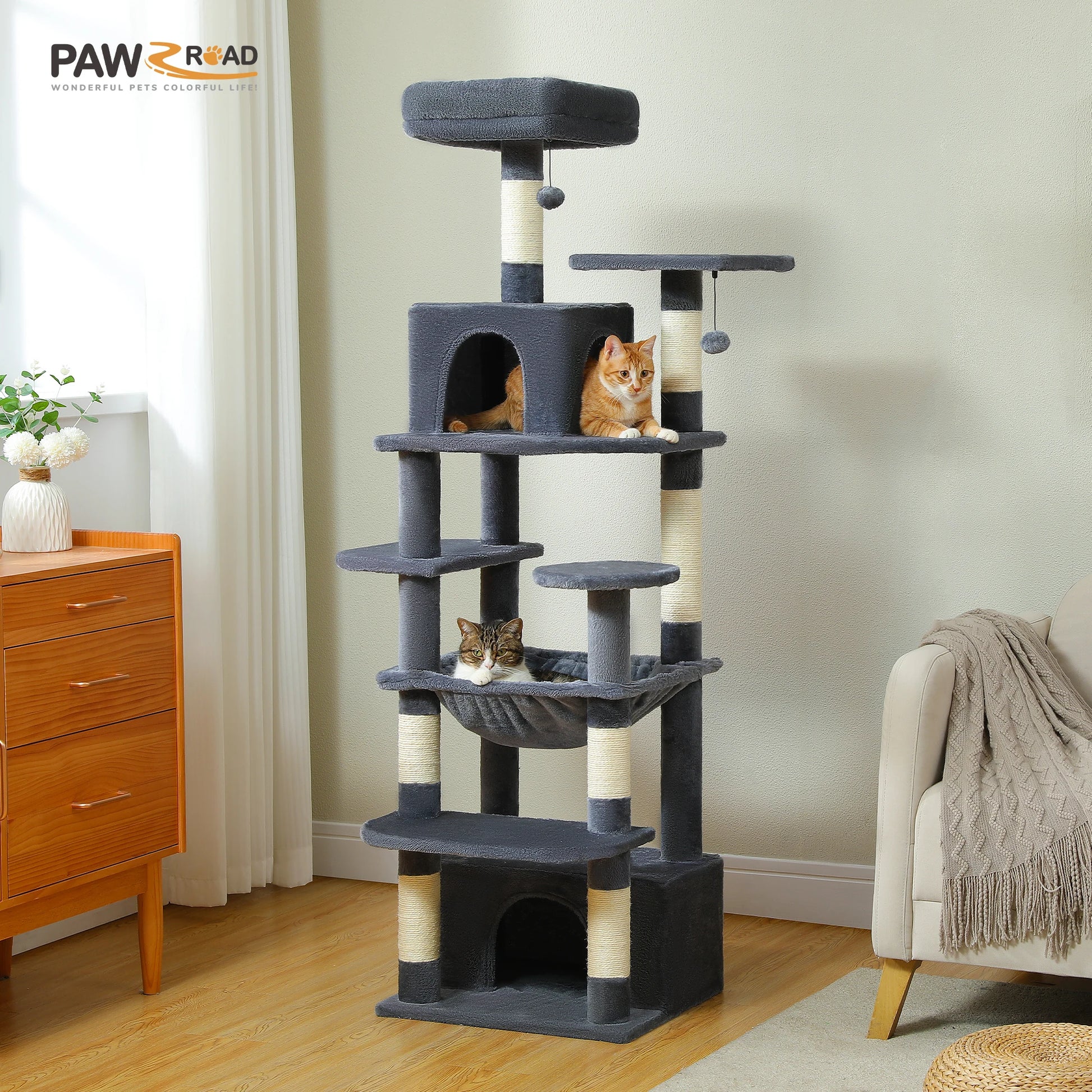 Cat tree with multiple levels and a cat sitting on top in a room setting.
